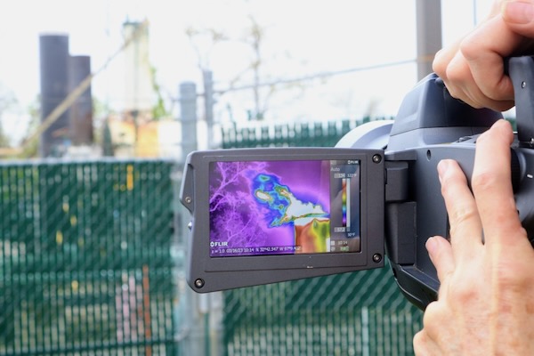 Sharon Wilson’s gas imaging camera captures otherwise invisible emissions from a gas compressor in Arlington on Thursday. Photo by Dylan Baddour for Inside. Climate News.