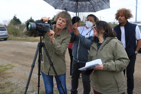 Sharon Wilson, an optical gas thermographer with Earthworks, shows images of gas emissions to EPA staff at a gas compressor in Arlington on Thursday. Photo by Dylan Baddour/Inside Climate News