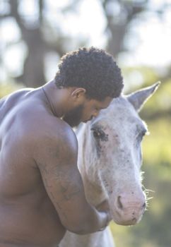 Former Dallas Cowboy David Carter pets horse