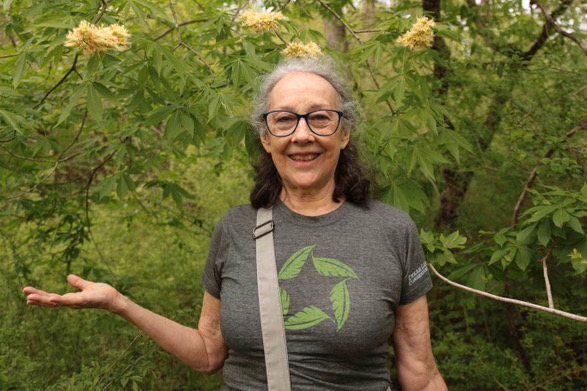 Eileen Fritz McKee poses with the Texas buckeye blooms her father popularized. Photo by Jennifer Weisensel. Courtesy of Wild DFW. 