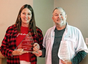 Kim Aman accepts the Environmental Educator Award from GSDFW Director Wendel Withrow. Photo by J.G. Domke.