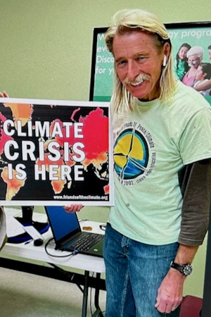 Dr. Alan Northcutt, leader of Waco Friends of the Climate, holds a yard sign given away by the group. Courtesy of Alan Northcutt.